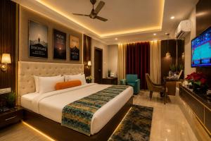 a hotel room with a bed and a television at Hotel ORIGIN Hyderabad Airport in Hyderabad +27 photos