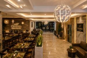 a restaurant with tables and chairs and a bar at Hotel ORIGIN Hyderabad Airport in Hyderabad