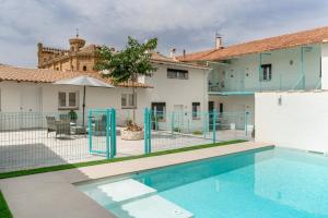 an apartment with a swimming pool in front of a building at Raízes 22 - Apartamento 5 in Puebla de Don Fadrique