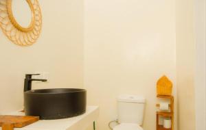 a bathroom with a sink and a toilet at Lilo House in Watamu +15 photos