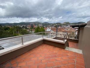 a balcony with a view of a city at Cavi Rooms 511 in Cuenca +8 photos