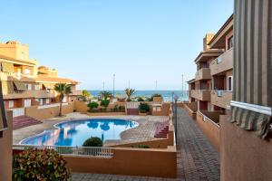 a view from the balcony of a building with a swimming pool at Residencial La Gomera in Puertito de Güímar