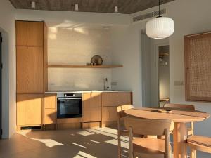a kitchen with a wooden table and a dining room at KITO suites in Kitriaí