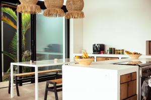 a kitchen with a white counter top and a table at Kibuye House in Kibuye