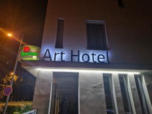 an art hotel sign on the side of a building at Art Hotel Podebrady in Poděbrady