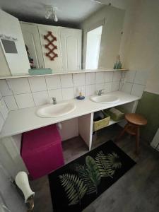 a bathroom with two sinks and a mirror at GITE EQUESTRE DE LA LANDE in Bréhal +18 photos