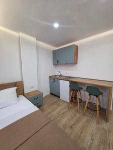 a bedroom with a bed and a desk with two chairs at Apartments Lati in Ulcinj