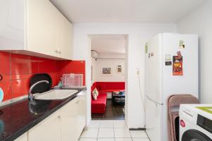 a kitchen with a sink and a refrigerator at Με συμπάθεια-With sympathy - private parking in Kavála