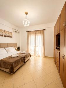 a bedroom with a bed and a large window at Guesthouse Zisi in Gjirokastër