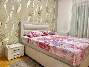 a bedroom with a bed with a pink comforter at Vila Giulietta in Kaštela +22 photos