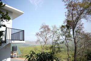 a view from the balcony of a house with trees at Vagamon leafhill mountain view holidays in Vagamon
