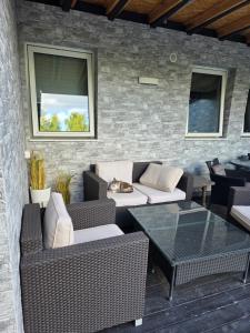 a patio with couches and a table with a cat laying on it at 1 sleeping room in Fagernes