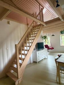 a wooden staircase in a room with a desk at Domek Kavalírek in Lipova Lazne