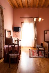a living room with a table and chairs and a window at Villa Bongiovanni in San Bonifacio