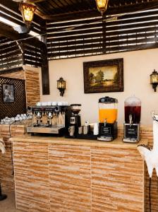 a kitchen with two coffee machines on a counter at El Amin Hotel & Suites - Downtown Cairo in Cairo
