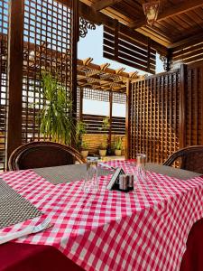 a table with a red and white checkered table cloth at El Amin Hotel & Suites - Downtown Cairo in Cairo