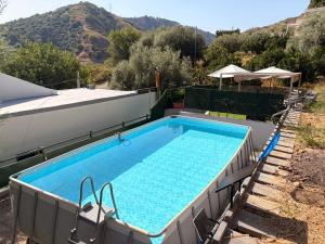 a large swimming pool in the middle of a yard at Quirin's Apartments in Taormina