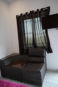 a chair in a room with a curtain at Vagamon leafhill mountain view holidays in Vagamon