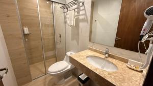 a bathroom with a toilet and a sink and a shower at Di Garda Hotel in Encarnación +44 photos