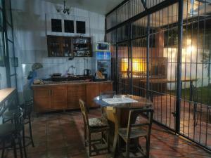a kitchen with a table and chairs and a sink at Hostel Ysapy en Piribebuy - Paraguay in Piribebuy +16 photos
