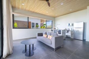 a living room with a couch and a table and a kitchen at Solindo Suite in Marbella