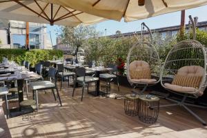 a patio with tables and chairs in bird cages at Hotel Caravita in Rome +95 photos