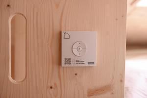 a lightswitch on a wooden wall with a plug at Tiny House Nook 2 - Green&Tiny Hideaway Eider in Süderstapel