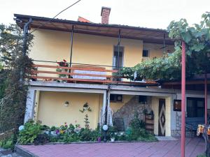 a house with a balcony on top of it at Руми in Velingrad