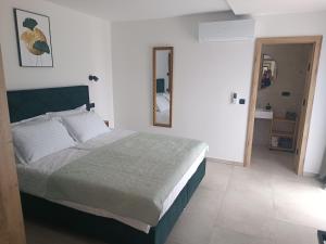 a bedroom with a large bed in a white room at Paradiso Beach House in Lopar