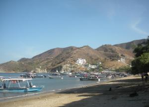 a group of boats are docked on a beach at Reina Elizabeth I in Santa Marta