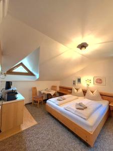 a bedroom with a large bed and a table at Appartements Baumanngut in Wagrain