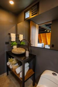 a bathroom with a sink and a toilet at GRETEL CHALETS SUIZO in Guatapé +56 photos