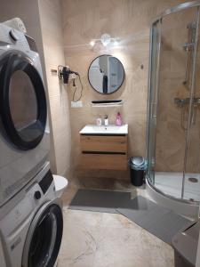 a bathroom with a washing machine and a sink at Baza Ślęża , Nowoczesny Apartament w sercu Sobótki in Sobótka +17 photos
