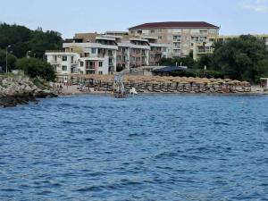 a large body of water with buildings in the background at Apartment А13 in Sea Paradise Complex in Kavarna