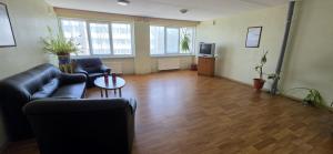 a living room with a couch and a table at LionEstateHostel in Liepāja