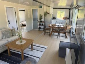 a living room with a couch and a table at Peppa Puhkemaja in Vahtrepa +12 photos