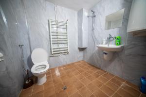 a bathroom with a toilet and a sink at Комплекс Петлето in Sokolovtsi +111 photos