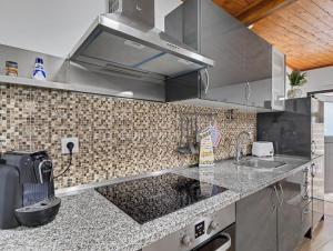 a kitchen with a sink and a counter top at Casa da Moleira in Amares +20 photos