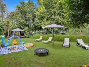 a backyard with a play area with a table and chairs and an umbrella at Casa da Moleira in Amares