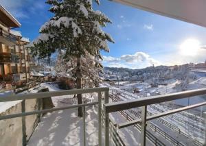 a winter view from a balcony with snow covered trees at Evasion in Orcières
