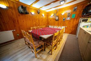 a dining room with a table and chairs in a kitchen at Комплекс Петлето in Sokolovtsi