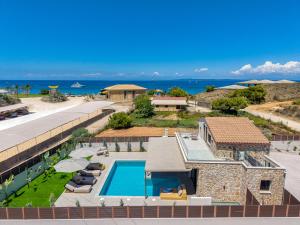 an aerial view of a resort with a swimming pool and the ocean at Alpha Waves By Banana Beach in Vasilikos