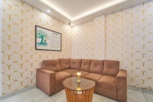 a living room with a brown couch and a table at Treebo Belita Resort Munnar With Infinity Pool in Munnar