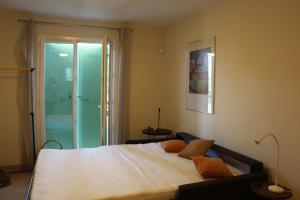 a bedroom with a bed and a sliding glass door at La Bastide des Marcassins in Moissac-Bellevue +24 photos
