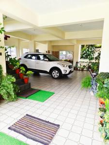a car parked inside of a house with a garage at The single room for two in Madikeri