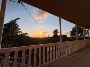 a view of the sunset from the porch of a house at Mamuka's Villa in Tsqaltsminda