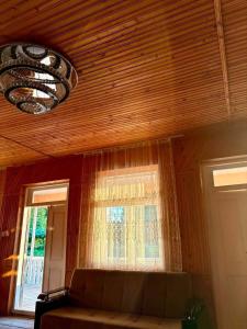 a living room with a couch and a window at Mamuka's Villa in Tsqaltsminda
