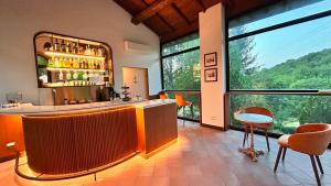 a bar in a room with a large window at Adagio Umbro in Sustrico Di Spoleto