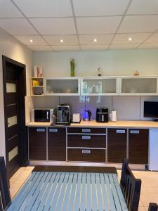 a kitchen with a counter with microwaves on it at Svetes house - Garden & BBQ & Parking in Liepāja