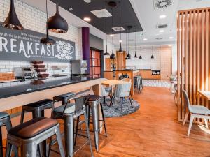 a fast food restaurant with a bar and stools at Premier Inn Mannheim City Centre in Mannheim